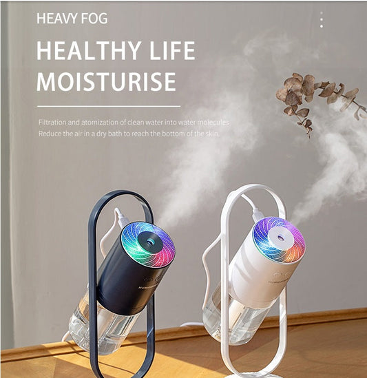 USB Mini Humidifier with LED light in black and white, releasing mist for air moisture in home or office. Rechargeable and stylish design.