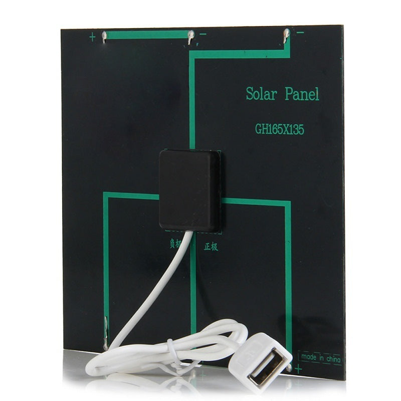 Close-up of Solar Power Bank Charger 4 in 1 charging dock station showing USB connector and labeled solar panel circuitry.