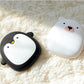 Penguin and polar bear USB Rechargeable Hand Warmers lying on a soft rug, ideal for cold weather outdoor adventures.
