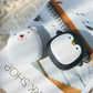 Polar bear and penguin USB Rechargeable Hand Warmers placed on a magazine, stylish and practical for hiking and camping.