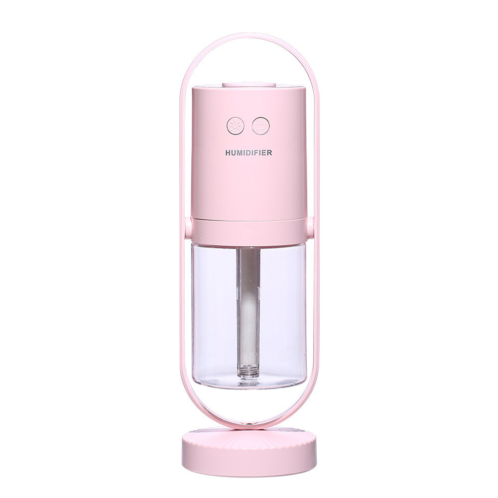 Pink USB Mini Humidifier with transparent tank and dual-button control, compact and rechargeable for home use.