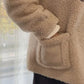 USB Rechargeable Hand Warmer tucked in coat pocket, demonstrating portability and convenience for hiking and camping.