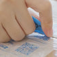 Close-up of hand opening a package with a cutter, possibly unboxing USB Rechargeable Hand Warmers for outdoor use.